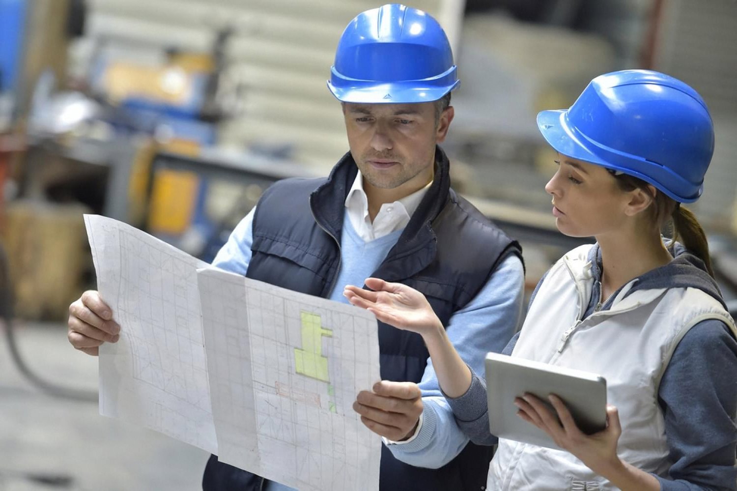 Two workers reviewing supplier plans and performance data at a UAE warehouse
